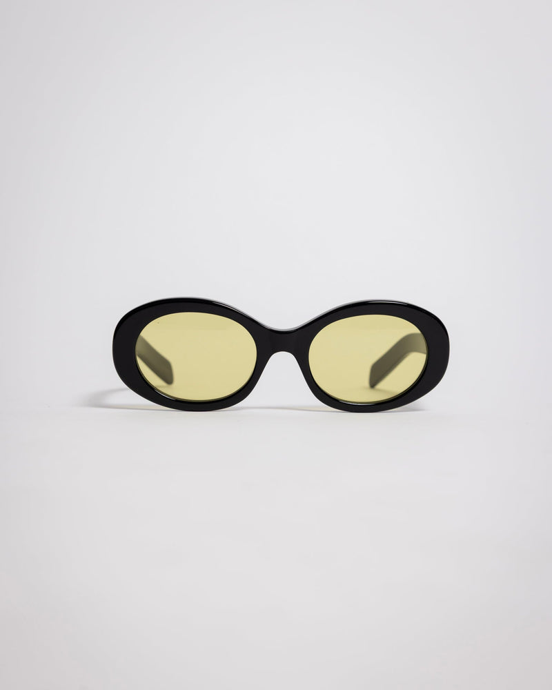 141 Waverly Pl, Side Eye oval sunglasses with black acetate frame and yellow tinted lenses [variant:Black / Yellow]